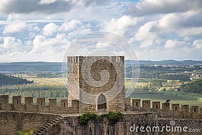 Medieval stone castle tower and walls close up with landscape and blue sky. Editorial Stock Photo