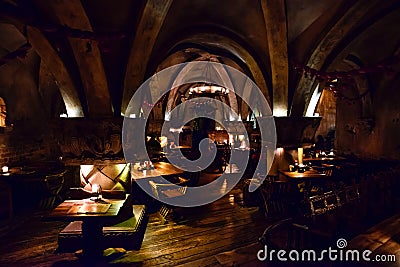 Medieval tavern. Shield on the wall. Barrels of beer. Stock Photo