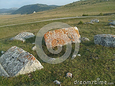 Medieval tombstones in a mountain pasture Stock Photo