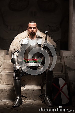 Medieval warrior in armor and fur mantle Stock Photo