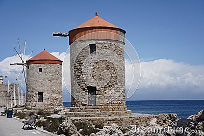 Medieval windmills of Rhodes town. Mandraki Harbour in the Dodecanese island of Rhodes Greece Stock Photo