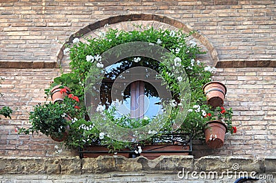 Medieval window with flowers pots Stock Photo