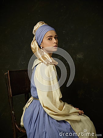 Medieval Woman in Historical Costume Wearing Corset Dress and Bonnet. Stock Photo