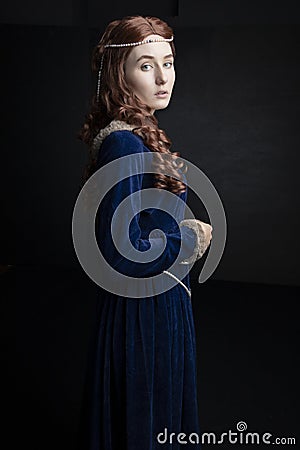 Medieval woman in a blue velvet dress Stock Photo