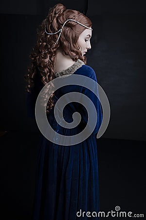 Medieval woman in a blue velvet dress Stock Photo