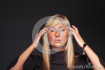 Meditating blonde middle aged woman portrait Stock Photo