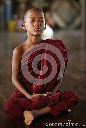 Meditating Buddhist novice in Yangon, Myanmar. Editorial Stock Photo