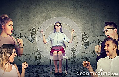 Meditating businesswoman paying no attention to crowd of screaming angry people Stock Photo