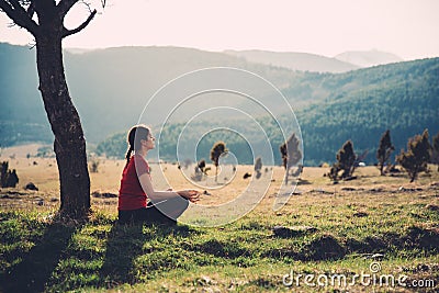 Meditating in nature on a sunny day Stock Photo