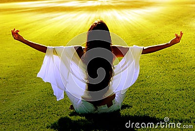 Meditation on a field in solar beams Stock Photo