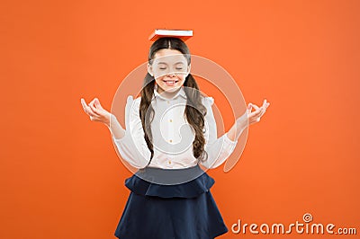 Meditation. Girl child hold book. School girl studying textbook. Kid school uniform hold book. Excited about knowledge Stock Photo