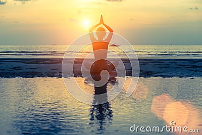 Meditation girl on the sea during sunset Stock Photo