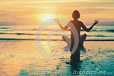 Meditation girl on the sea during sunset. Stock Photo
