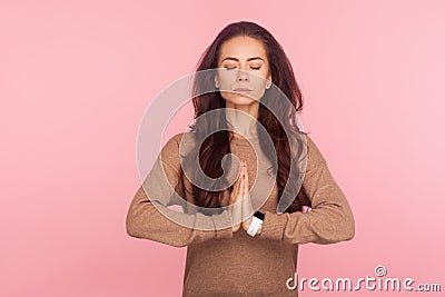 Meditation, peaceful mind. Portrait of calm concentrated young woman holding hands in namaste gesture Stock Photo