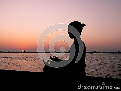 Meditation at sunset Stock Photo