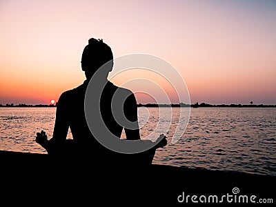 Meditation at sunset Stock Photo