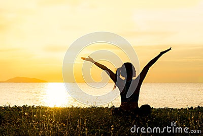 Meditation yoga lifestyle woman silhouette on the Sea sunset, relax vital. Stock Photo