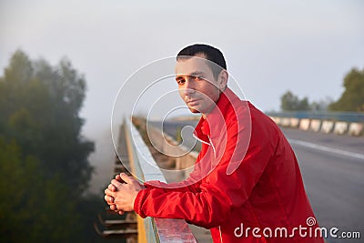 Meditative brunette man on a bridge on a foggy morning Stock Photo