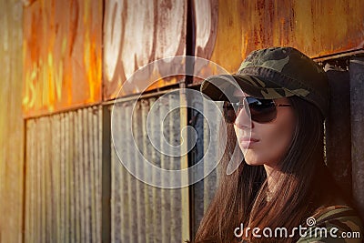 Meditative Young Woman Soldier in Camouflage Outfit Stock Photo