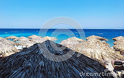 Mediteraneean blue sea beach umbrellas Stock Photo