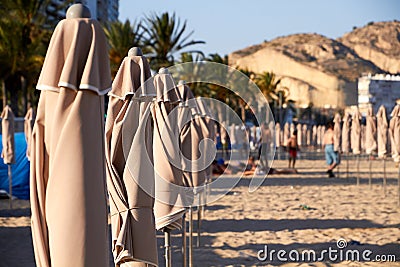 Mediterranean beach with some folded umbrellas Stock Photo