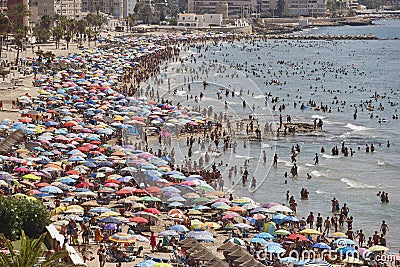 Mediterranean coastline in Spain. Calpe beach. Summer crowd. Alicante Stock Photo