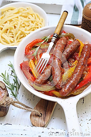 Mediterranean cuisine. Fried sausages stewed in bell pepper, onion and tomato sauce Stock Photo