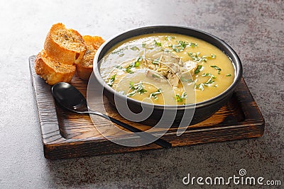 Mediterranean diet cream soup of artichokes, potatoes, leeks and garlic served with toast close-up in a bowl. Horizontal Stock Photo