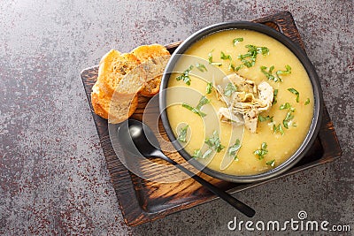 Mediterranean diet cream soup of artichokes, potatoes, leeks and garlic served with toast close-up in a bowl. Horizontal top view Stock Photo