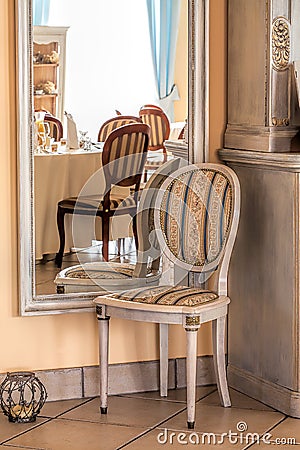 Mediterranean interior - mirror and chair Stock Photo
