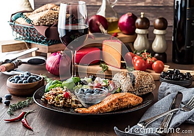 Mediterranean meal including greek salad, seven grain salad, salmon and blueberries. Mediterranean diet concept. Stock Photo