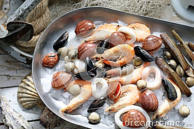 Mediterranean, raw seafood mix on a metal plate. Marine composition, selective focus. Fish shop assortment. Stock Photo