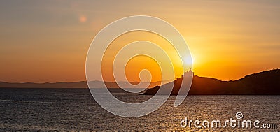 Mediterranean sea. Beautiful sunset and a lighthouse at Kea island, Greece. Stock Photo