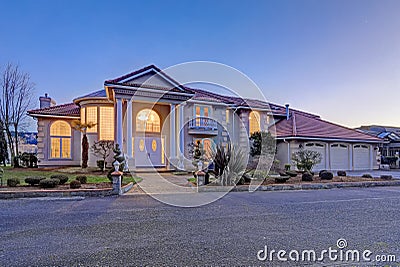 Mediterranean style waterfront home with stucco walls and columned porch Stock Photo