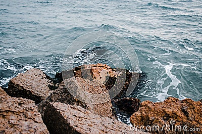 Mediterranean winter stormy seaside. Close up water with stones on the beach concept photo Stock Photo