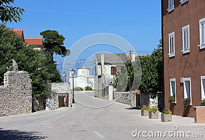 Mediterranian street view with the tiny church and mountains Stock Photo