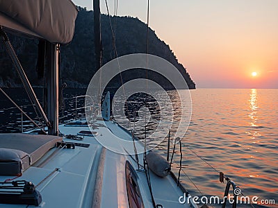 Meet the sunset in the Bay on Board the yacht, a romantic evening at sea. Boat trip on a yacht under sail. Stock Photo