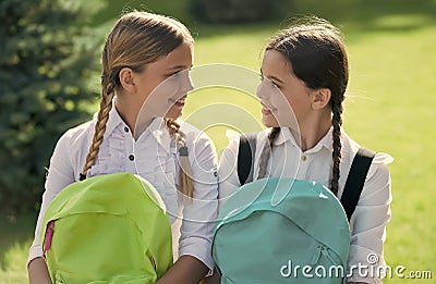 Meet your best friends today. Happy girls hold school bags. Girls education. Back to school. Beauty look. Hair salon Stock Photo