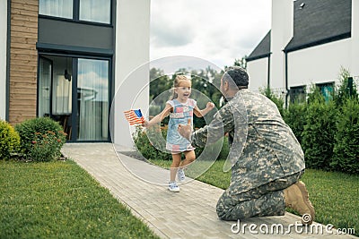 Military servant meeting his cute lovely girl near the house Stock Photo