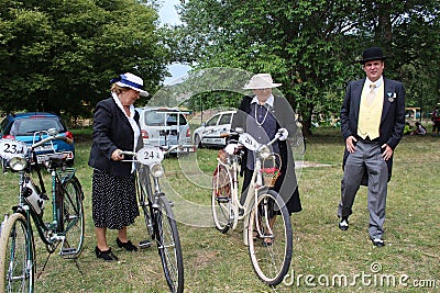 Meeting of Historical Bicycles - a lady in a vintage costume with corresponding bike Editorial Stock Photo