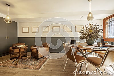 meeting and recreation room with work table and vintage armchairs upholstered Stock Photo