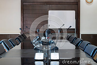 Meeting room the modern meeting room has a microphone positioned seating. The chair around the table is black. Used for meetings Stock Photo