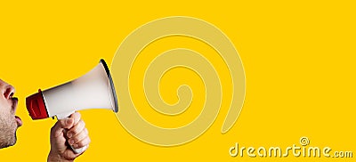 Megaphone speaking announcing against isolated on yellow solid background Stock Photo