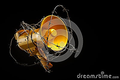 Megaphone wrapped in barbed wire. the concept of banning freedom of speech. censorship barbed wire megaphone Stock Photo