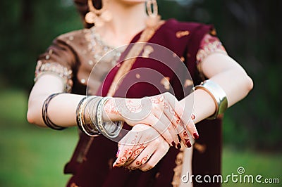Mehndi tattoo. Woman Hands with black henna tattoos. India national traditions. Stock Photo