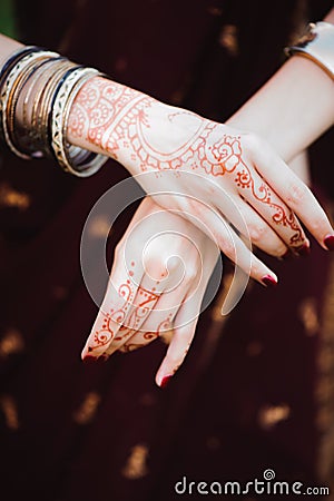 Mehndi tattoo. Woman Hands with black henna tattoos. India national traditions. Stock Photo
