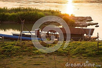 Mekong river, Laos and Thailand at Huay Xai. Traditional wooden boats at sunset Stock Photo