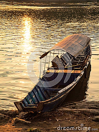 Mekong river, Laos and Thailand at Huay Xai. Traditional wooden boats at sunset Stock Photo