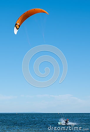 Kite surfer making splashes in water. Editorial Stock Photo