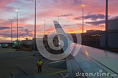 MELBOURNE, AUSTRALIA - JULY 30, 2018: Ground staff is standing by near a plane ready to take off at Melbourne Airport in the Editorial Stock Photo